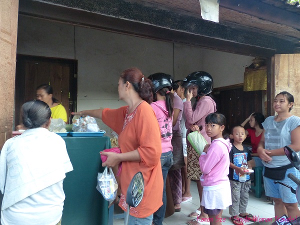Balinese women buy take out food in Ubud, Bali, Indonesia