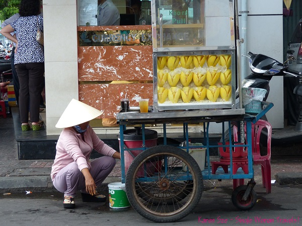 Vietnamese woman with hat, long sleeve top, pants, socks and sandals